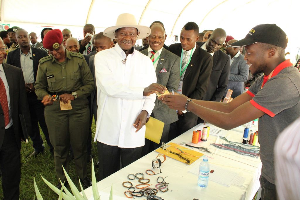  - One of the exhibitors receives a token of appreciation from the president during the Makerere University Agricultural Day and Exhibition