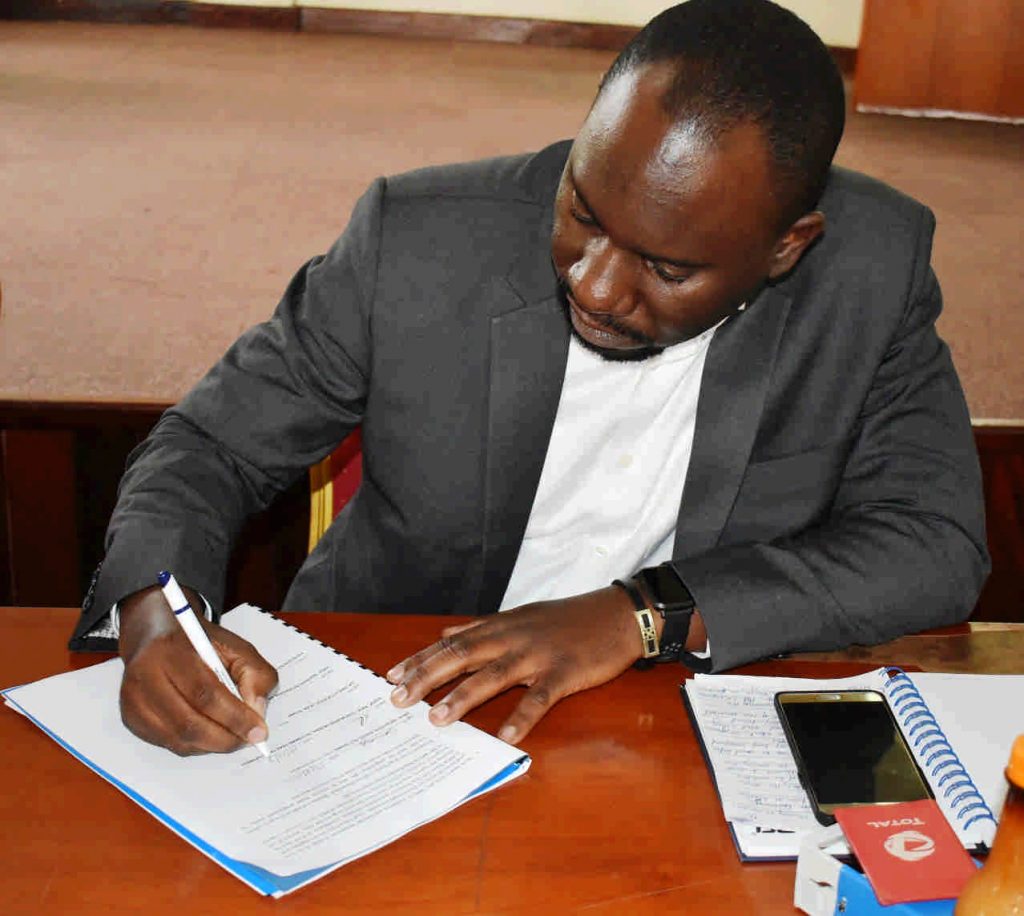 - Dr. Ivan Muzira Mukisa signs the hand over report