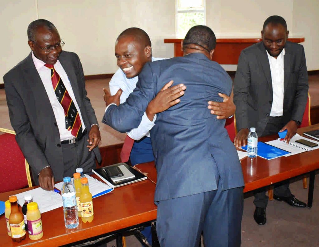  - The Dean Dr. Abel Atukwase hugs and thanks Prof. Kaaya for the job welldone